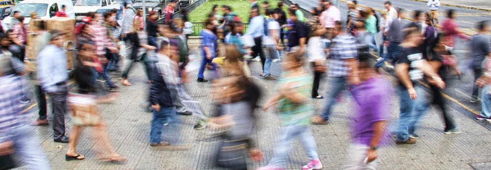 blurred photo of people crossing a street